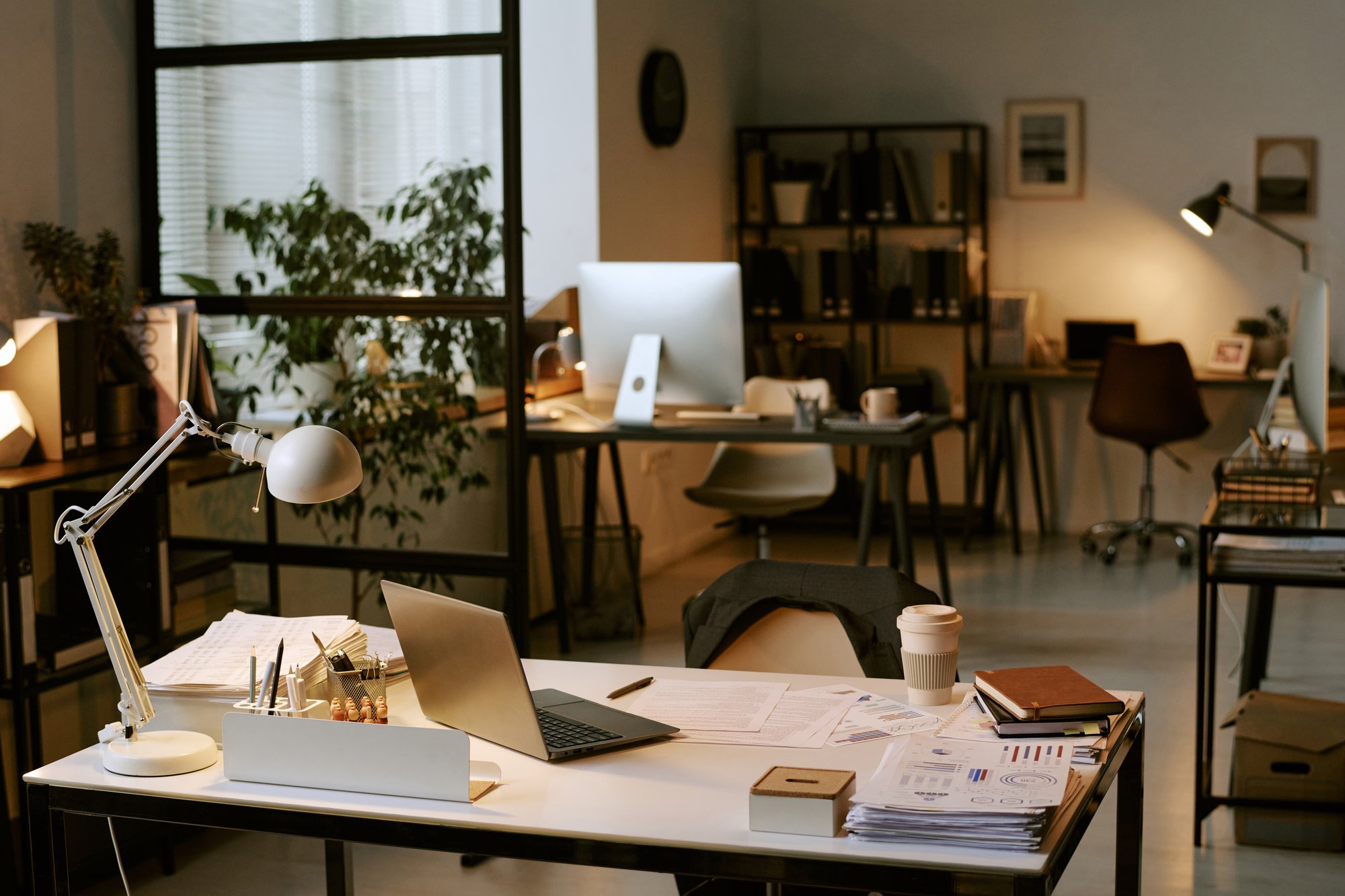 Laptop and expense documentation on a desk during card transaction reconciliation